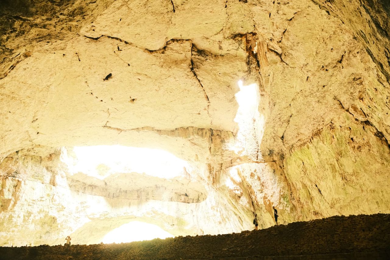 Bright daylight pouring through a broad opening in Devetashka Cave