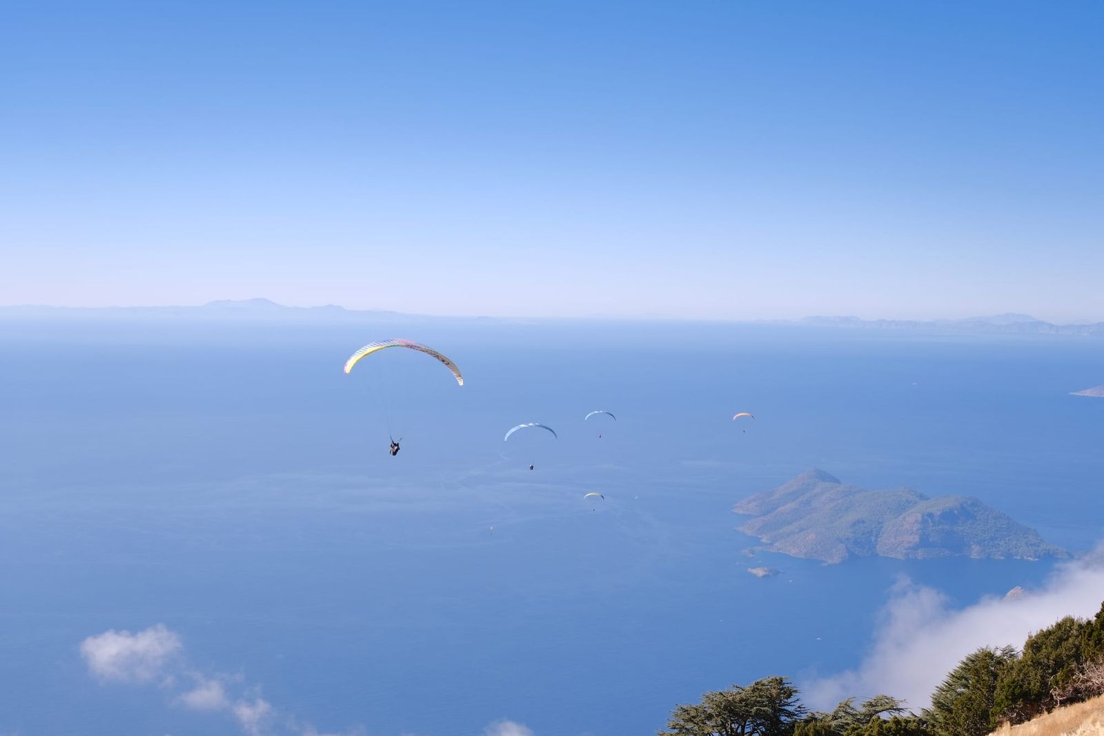 Paraglider flying above the sea and islands off Babadağ
