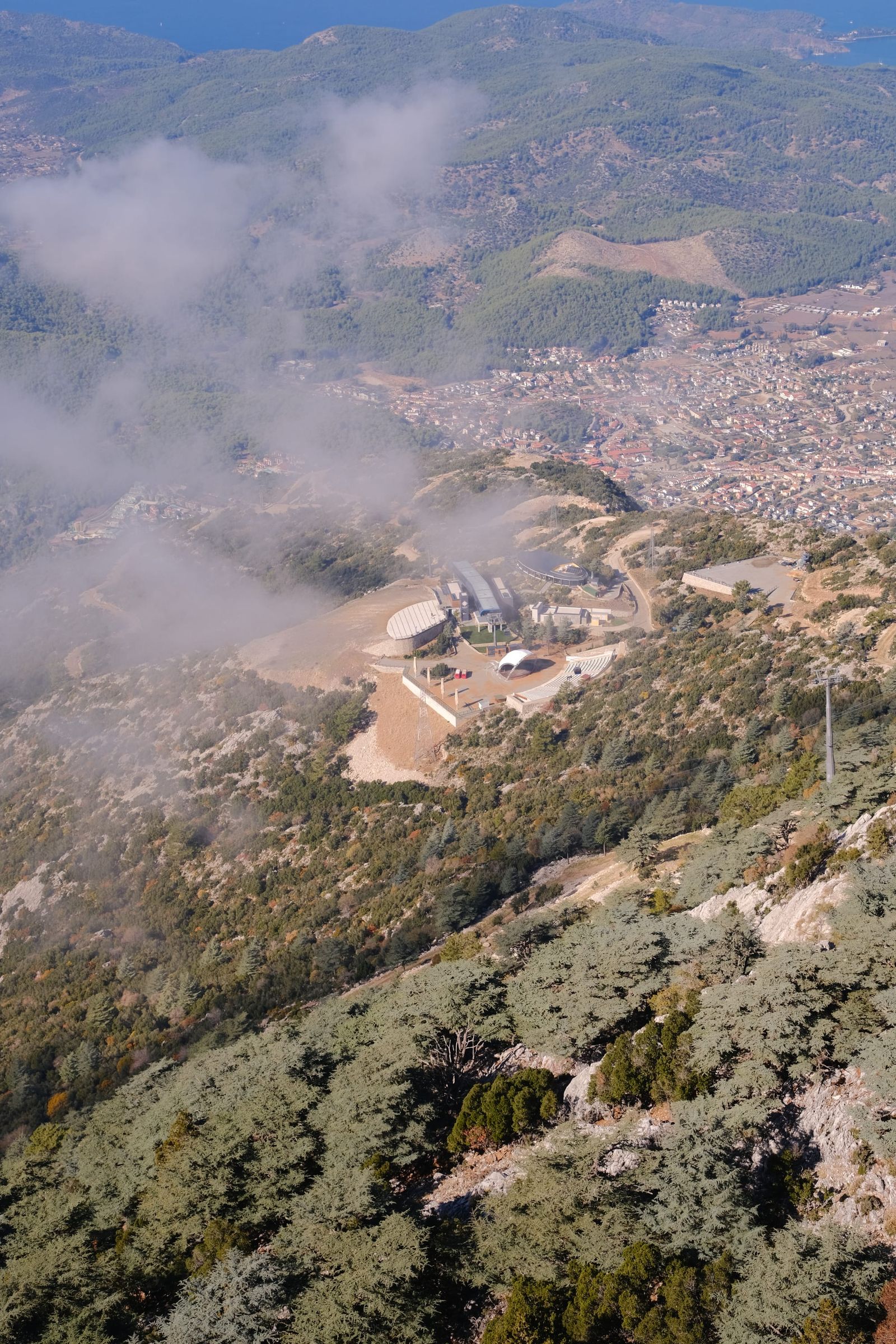 Mountain launch area and town seen through drifting cloud
