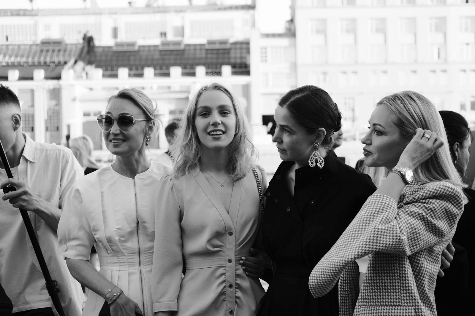 Four women gather together outside the venue in a black-and-white photograph.