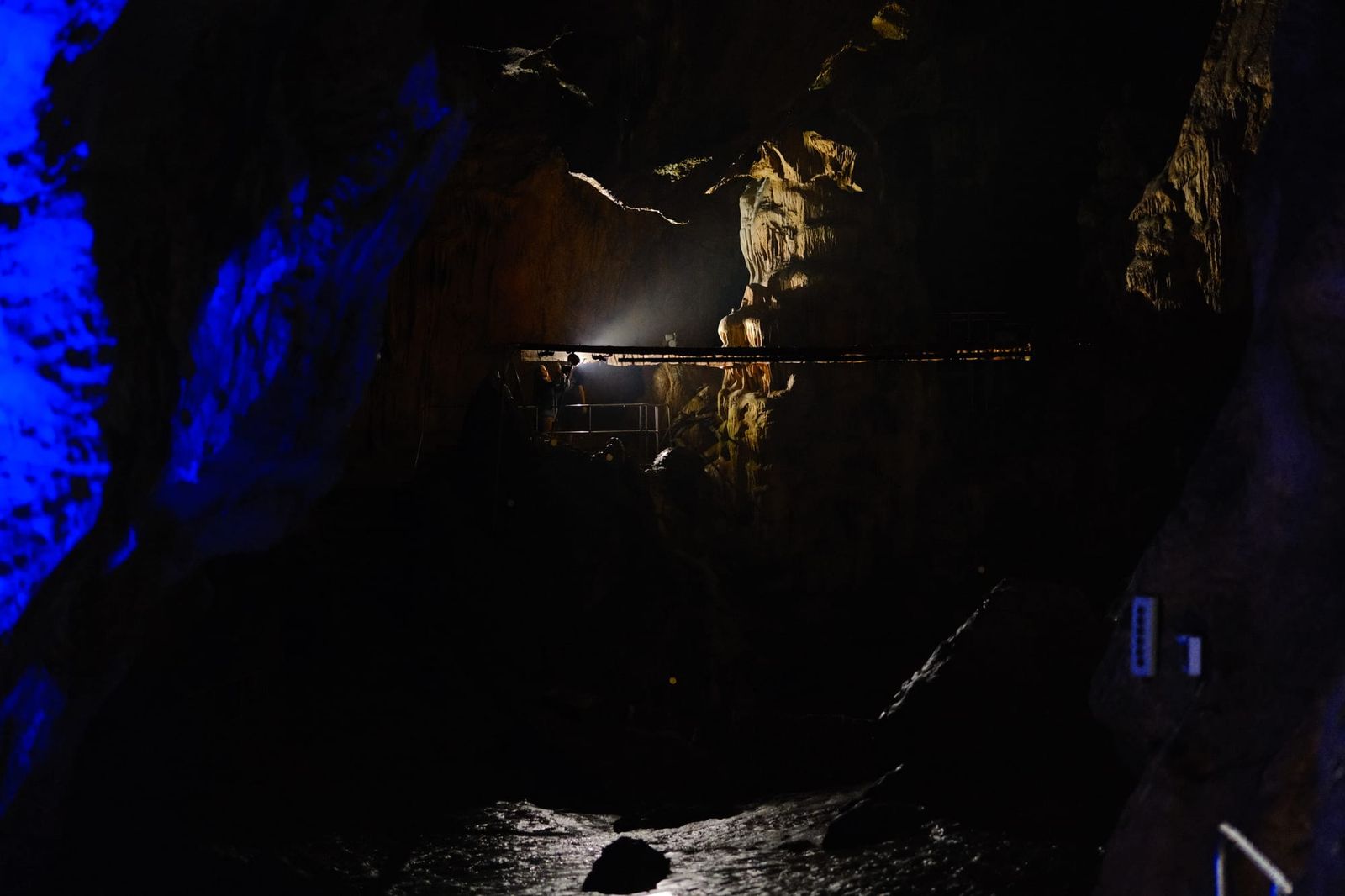 Blue-lit cavern and footbridge inside Ledenika Cave