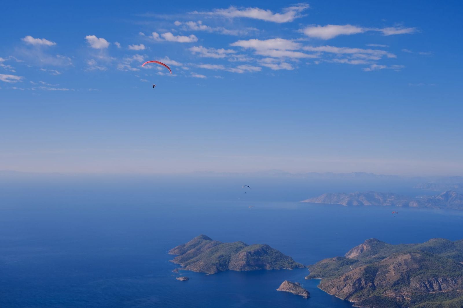Paraglider above the sea and rocky islands off the Turkish coast