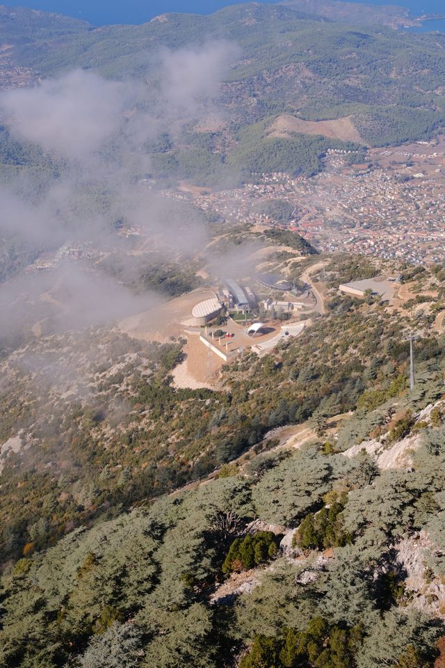 Mountain launch area and town seen through drifting cloud