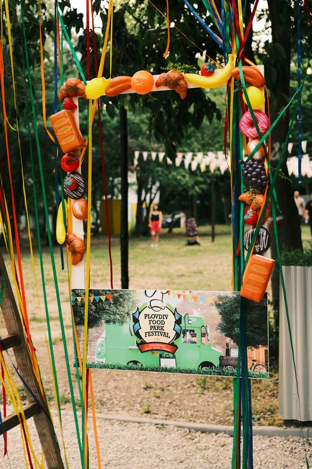 Colourful ribbons and fabric flowers frame an entrance to the food festival.