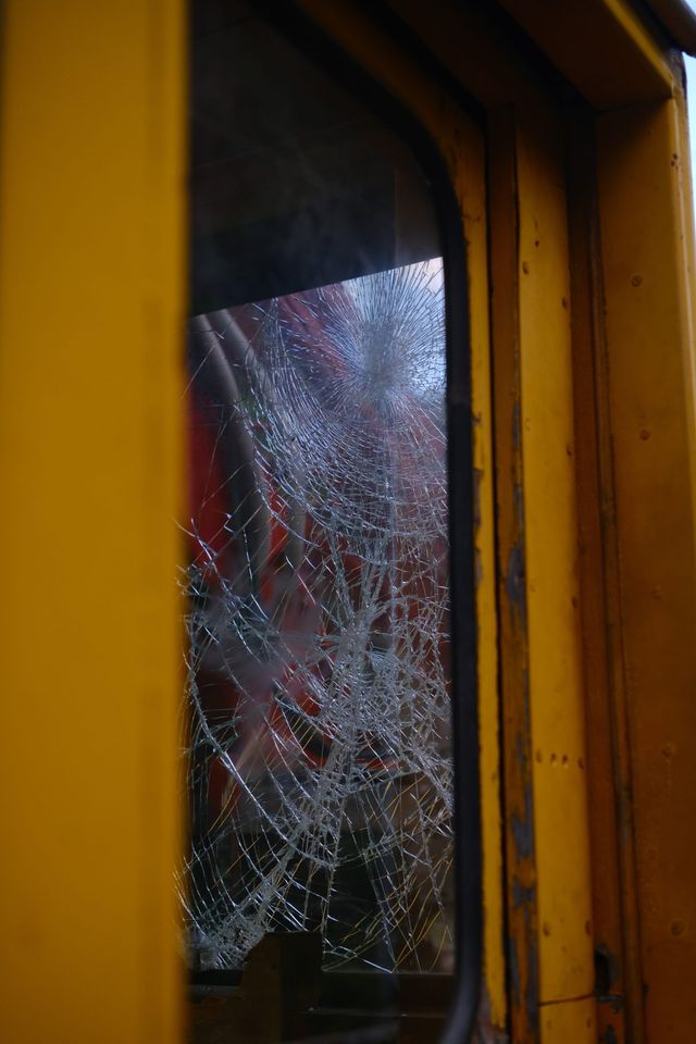 Cracked window in the yellow railway service vehicle